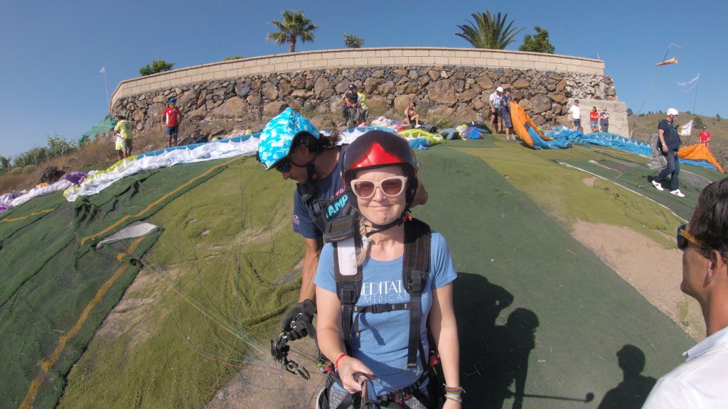 Me holding the go-pro with the selfie stick, being hooked up to the paragliding harness. My face looks a little like "Why am I doing this again?"